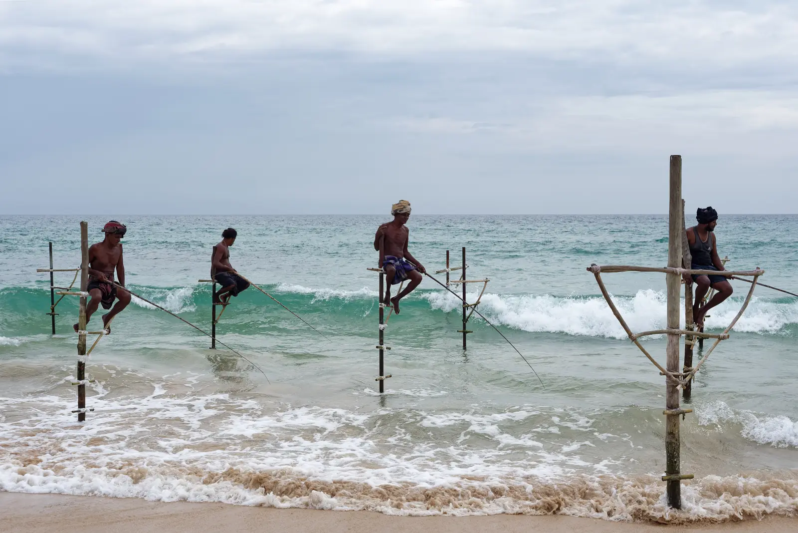 Traditional stilt fishermen in the shallows near Ahangama, Sri Lanka