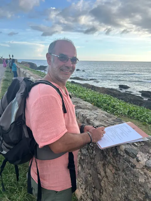 A traveller filling in our survey on the Galle Fort ramparts